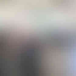 Participants of the CCA mission seated in a circle inside Hacienda Alsacia, Starbucks’ research center, during a knowledge-sharing session, with chairs arranged and the brand logo visible on the wall.