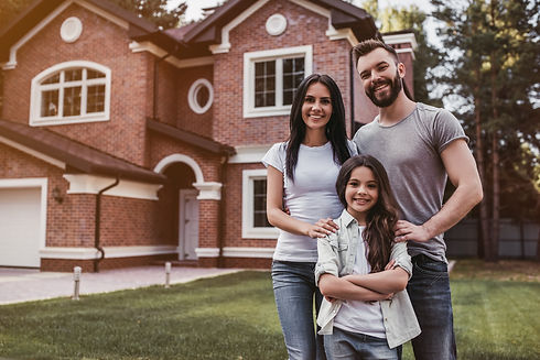 Dad, mom, child outside their new home.