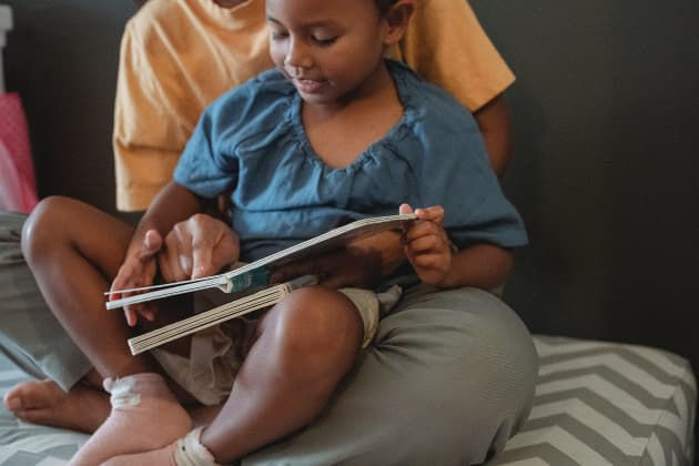 A man reading a book with a child