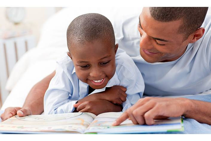 A man and a child have fostering early literacy development