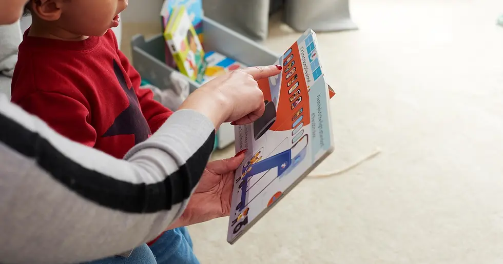child reading a book with adult support