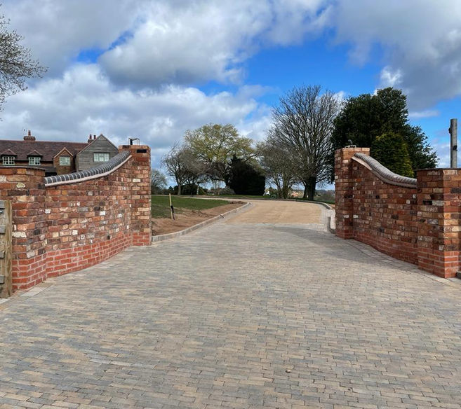 Brick wall entrance to a drive
