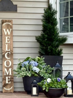 Spring front porch styling featuring a custom hand-painted welcome sign and seasonal decor in West Hartford, CT.