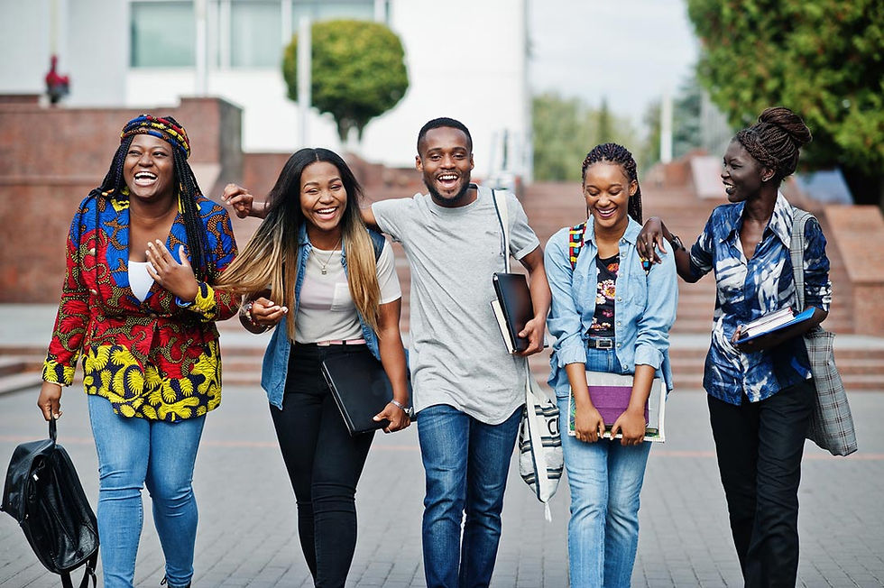 Group of people walking down college campus smiling