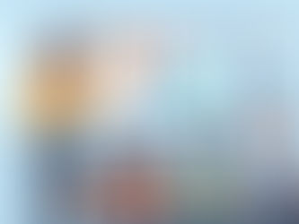 Teacher presenting with a digital interactive whiteboard to three students seated at desks with laptops in a bright, modern classroom.