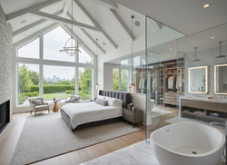 Spacious custom home master bedroom suite with vaulted ceilings and luxury finishes