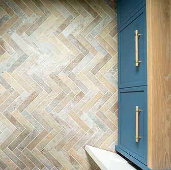 Herringbone Tile Floor with Teal Cabinets
