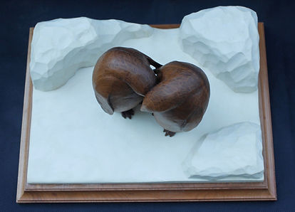 Wood carving of emperor penguins