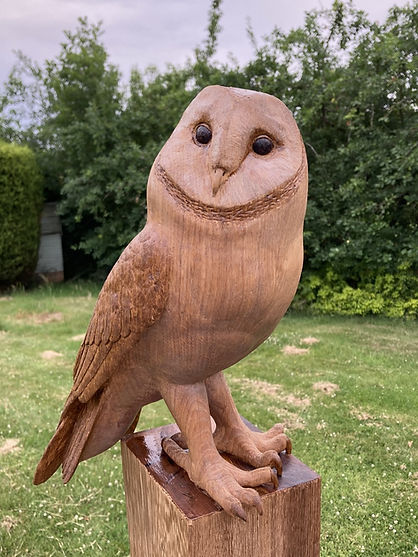 Wood carved Barn Owl on a post