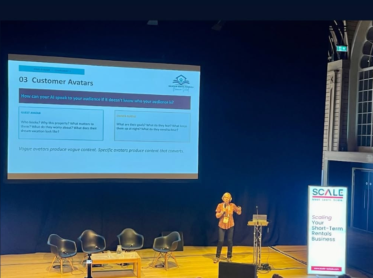 Photo of a presentation at the conference, with a background slide reading "how can your AI speak to our audience if it doesn't know who your audience is?"