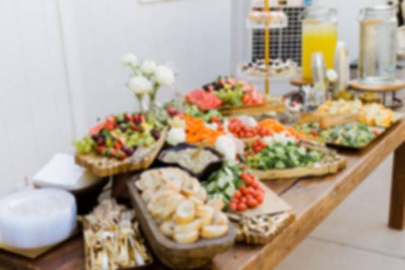 a buffet table set for a grazing table for a wedding