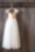 Wedding dress against barn wall.