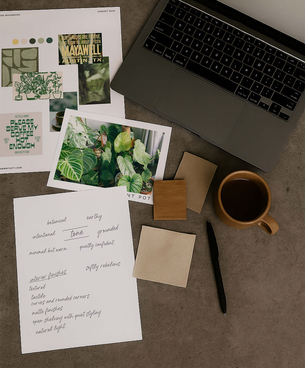 Concept deck, brand moodboard and notes for a new cafe business, scattered on a desk with a coffee and laptop.