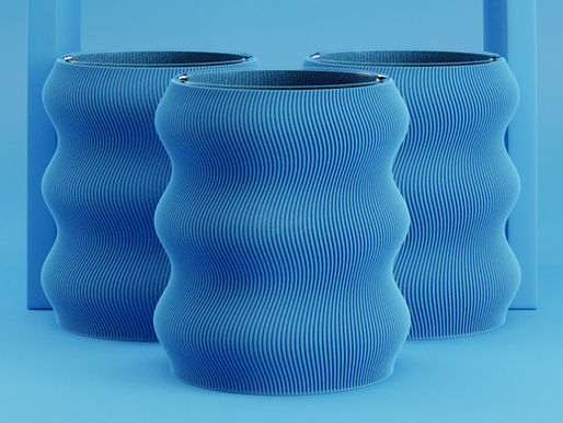 Three blue vases with wavy, ribbed textures stand against a matching blue background, creating a harmonious, serene visual.