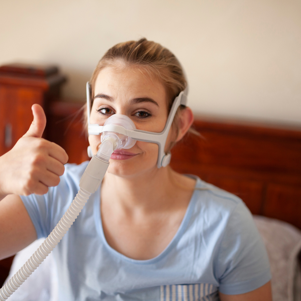 A happy customer with a CPAP mask and machine