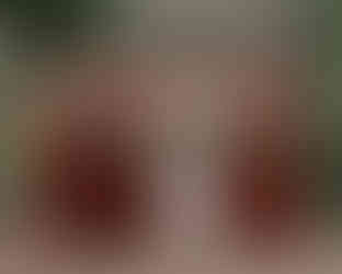 Bride and groom with bridesmaids and groomsmen at Michelham Priory wedding, group photo under medieval arch.