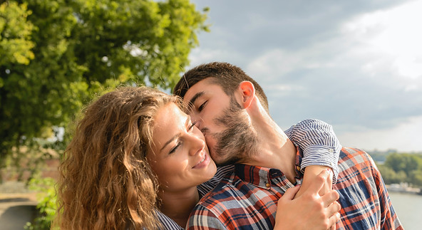 Happy Man and Woman kissing in nature