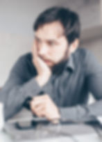 Sad man looking away with head in hand