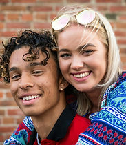 Happy Mixed race couple outdoors brick background.jpg
