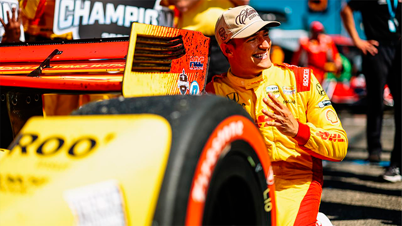 Alex Palou junto a su auto celbrando su cuarto título como campeón de la IndyCar Series