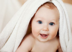 bigstock-A-beautiful-smiling-baby-wrapp-27329180.jpg