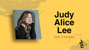 Woman with long hair poses thoughtfully against a gray background. "Judy Alice Lee, 2026 Trailblazer" text on yellow backdrop.