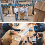 Team reviewing logistics in a warehouse and architectural plans.