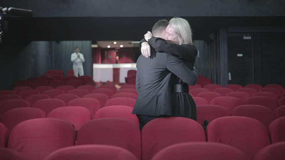 Young woman holding her partner in her arms in a Parisian cinema after a marriage proposal