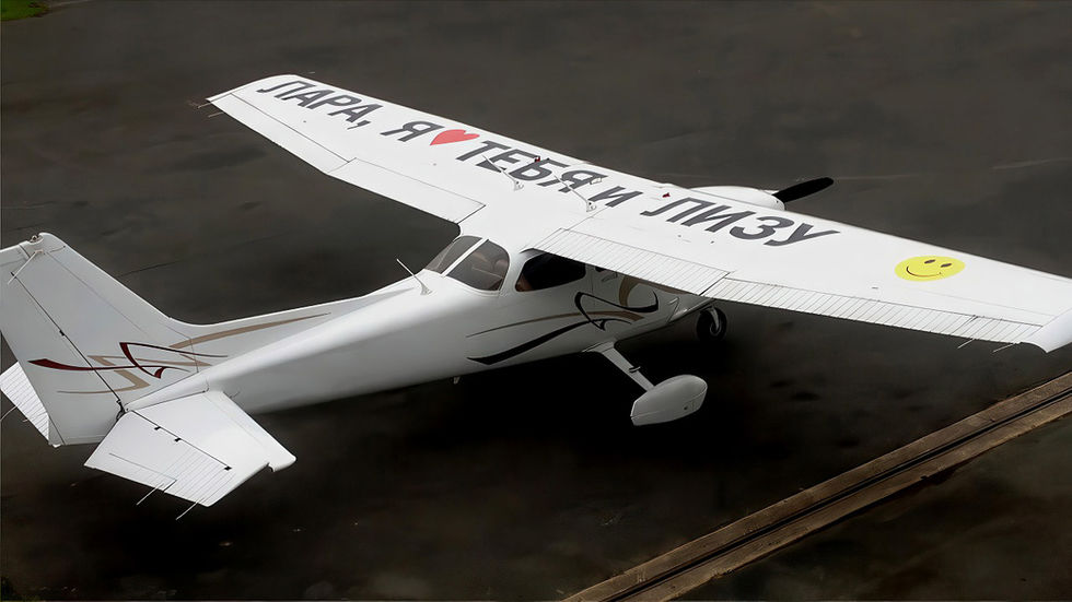 Cessna 172 parked on the tarmac with a love message in Russian written on its wings