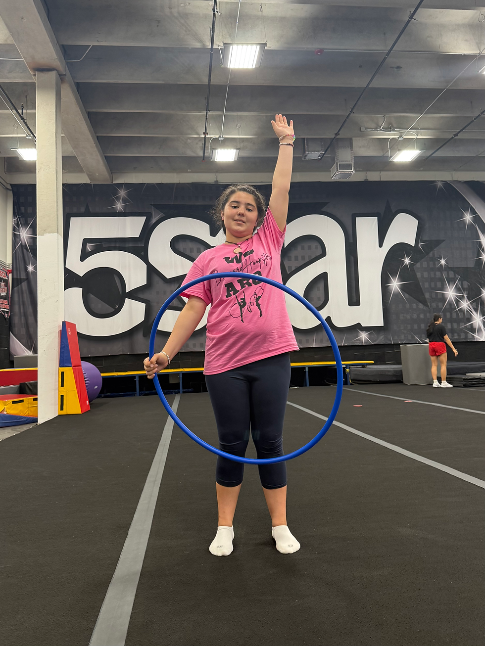 Olivia, Broward County Level 1 gymnast, saluting before running through her hoop routine.