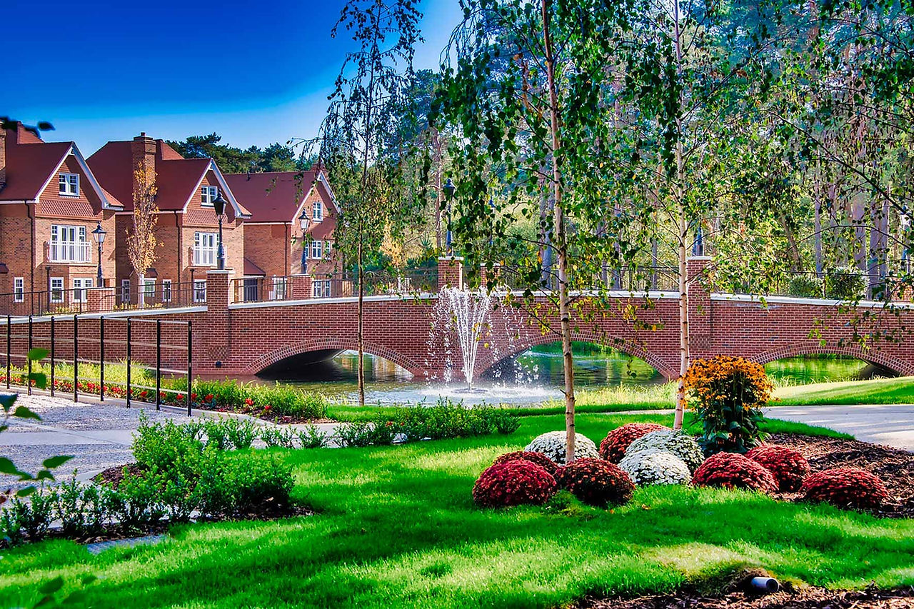 Bridge surrounded by grass and flowers