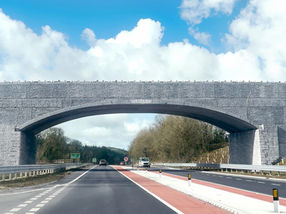 Large concrete arch over a dual carriageway