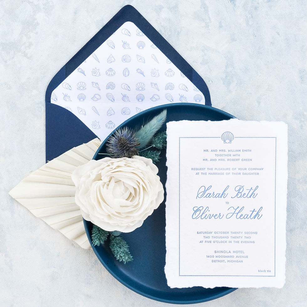 photo of a wedding invite printed on handmade paper with a matching envelope