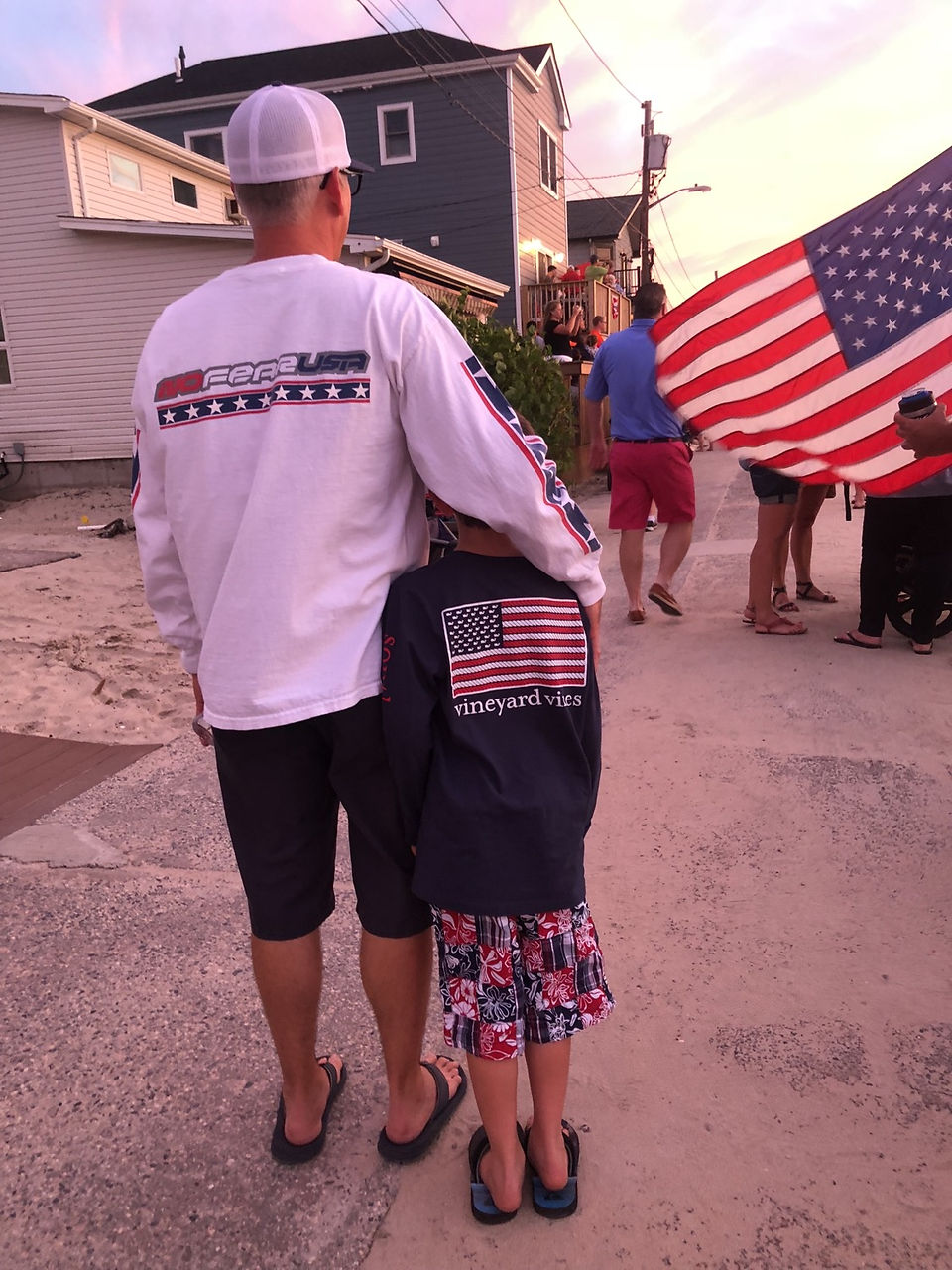 A father and son in American patriotic clothing at an Independence Day Celebration 