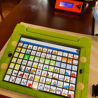 Green iPad case with a keyguard it has two pieces of velcro on the left and right sides of the case