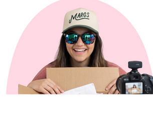 Headshot of the owner of North 131 opening a box on camera