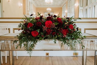 Rich red ceremony table flowers