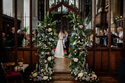 church flower arch, with ivory, blue and pink