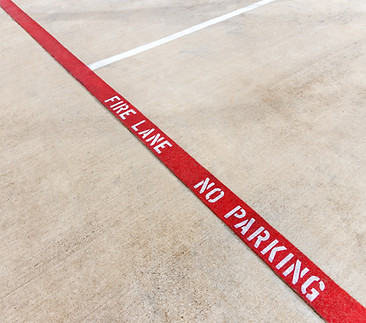 Fire lane no parking marking on the asphalt of a parking lot, tow away zone, red fire lane