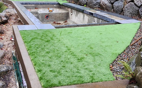 Construction of outdoor pool against newly laid grass.