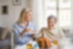 A private caregiver and an elderly client enjoy a meaningful conversation, exemplifying the compassionate connection that enhances Fort Worth senior care.