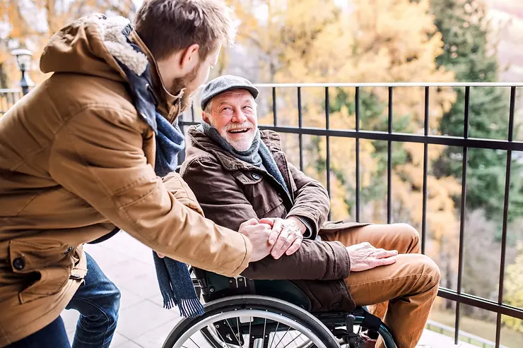 A senior and caregiver enjoy a moment of companionship, representing the enriching gift of ADL services to families.