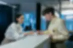 Professional front desk receptionist seamlessly combining concierge desk management with vigilant security agent duties, enhancing security consulting efforts.