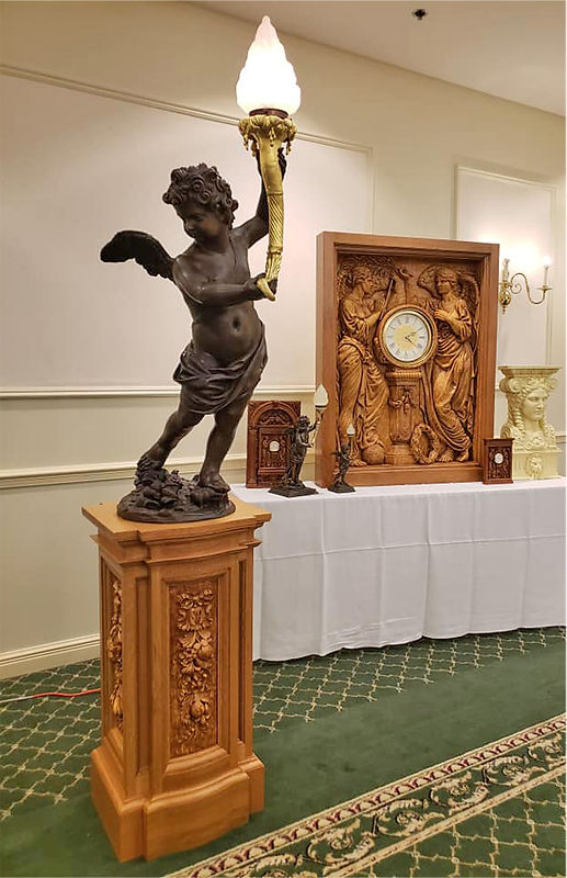 Titanic bronze cherub replica on quarter-sawn white oak pedestal at the Titanic Historical Society Convention in 2018.jpg