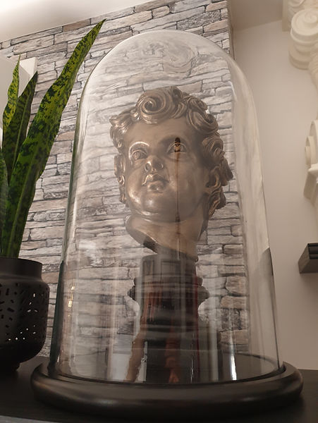 Titanic cherub head by sculptor Alan St George displayed under glass
