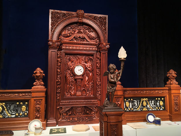 Titanic Grand Staircase with clock, cherub lamp, and balustrades.