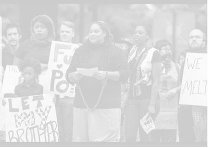 People at a protest holding signs like "LET MY BROTHER GO" to protest police brutality.