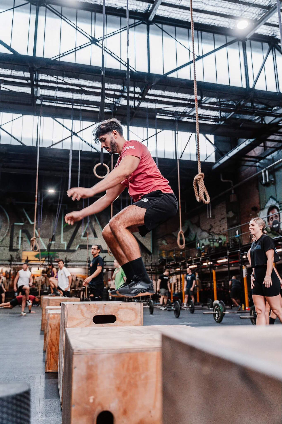 CrossFit athlete mid-air in a box jump at CrossFit Torian