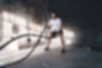 Man training with battle ropes