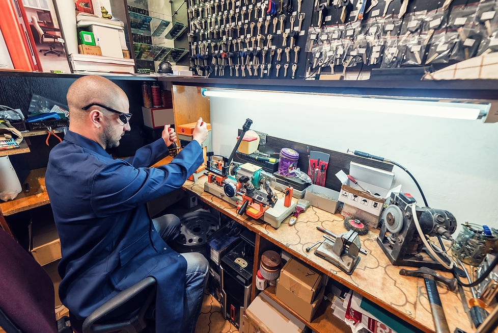 locksmith in workshop makes new key.jpg